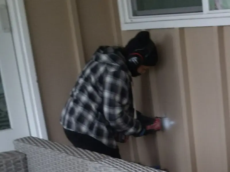 Professional electrician installing an exterior outlet in Rossville